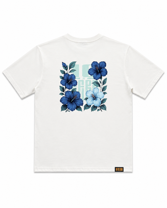 Blue Sauvage Tee in Off White – back view with blue hibiscus floral print over 10 to Zero graphic