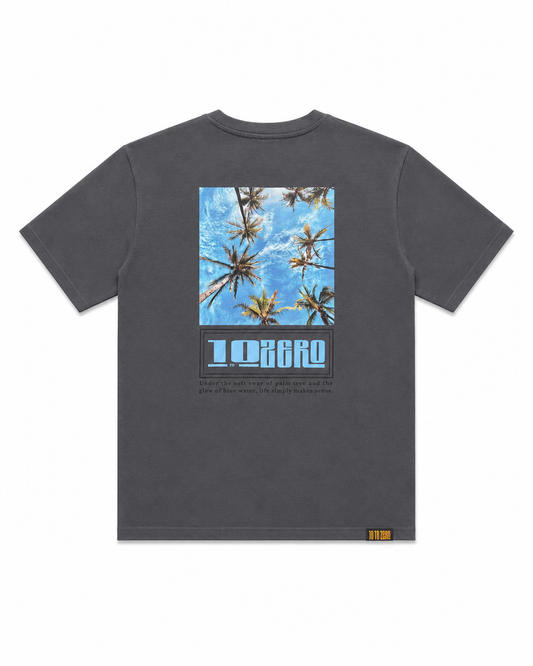 Coastal Dreams Tee in Asphalt – back view with upward palm tree sky photo print and 10 to Zero graphic