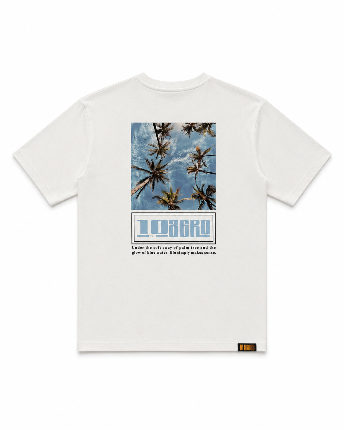 Coastal Dreams Tee in Off White – back view with upward palm tree sky photo print and 10 to Zero graphic