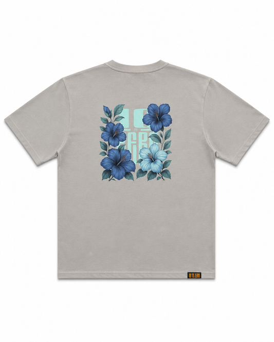 Blue Sauvage Tee in Dizzle Grey – back view with blue hibiscus floral print over 10 to Zero graphic